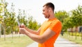 Smiling young man with smartphone and earphones Royalty Free Stock Photo