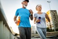 Fitness, sport, people, exercising and lifestyle concept - senior couple running Royalty Free Stock Photo