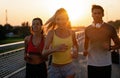 Fitness sport people running lifestyle concept. Group of young people jogging together outdoors. Royalty Free Stock Photo