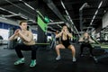 Fitness, sport, training, gym and lifestyle concept - group of smiling people exercising in the gym, doing squats Royalty Free Stock Photo