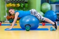 Fitness, sport, training, gym and lifestyle concept - young woman doing exercise on fitness ball Royalty Free Stock Photo