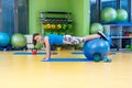 Fitness, sport, training, gym and lifestyle concept - young woman doing exercise on fitness ball Royalty Free Stock Photo