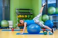 Fitness, sport, training, gym and lifestyle concept - young woman doing exercise on fitness ball Royalty Free Stock Photo