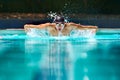 Fitness, sport and training with man in swimming pool for competition, workout and energy. Strong, water splash and Royalty Free Stock Photo