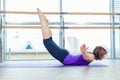 Fitness, sport, training and people concept - smiling woman doing abdominal exercises on mat in gym Royalty Free Stock Photo