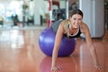 Fitness, sport, training and people concept - smiling woman flexing abdominal muscles with exercise ball in gym Royalty Free Stock Photo
