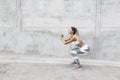 Fitness sport woman in fashion sportswear doing workout over gray wall Royalty Free Stock Photo