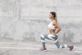 Fitness sport woman in fashion sportswear doing workout over gray wall Royalty Free Stock Photo