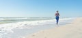 Morning run along the coast.Woman doing exercises on the beach, meet the sunrise.Fitness, sport, yoga and healthy lifestyle concep Royalty Free Stock Photo