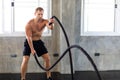 Fitness and sports man training with battle rope in cross fit gym. Fitness Healthy lifestye and workout at gym concept Royalty Free Stock Photo