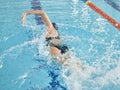 Fitness, sports and a swimming woman for training, competition or exercise in a pool. Stroke, active splash and a Royalty Free Stock Photo