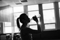 Fitness sporty girl silhouette excercising and drinking a water