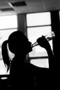 Fitness sporty girl silhouette excercising and drinking a water