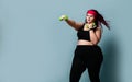 Fitness spring diet weight loss concept. Lucky plus-size girl overweight woman dieting working out with green weights dumbbells