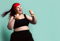 Fitness spring diet weight loss concept. Screaming loud plus-size overweight woman does exercises with weights dumbbell