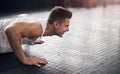 Fitness starts with that first push. a young man doing pushups in a gym. Royalty Free Stock Photo