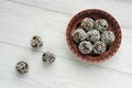 Fitness sweets made of nuts and dates on a white wooden background