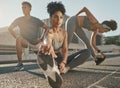 Fitness, team and friends stretching in city street for exercise run, marathon training run or cardio performance