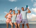 Fitness team. A happy group of runners rest after running along the sea coast. Sports concept for social media Royalty Free Stock Photo