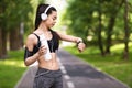 Fitness Tracker Concept. Sporty Asian Girl Looking At Smartwatch On Her Wrist Royalty Free Stock Photo