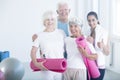 Fitness trainer congratulating elderly people Royalty Free Stock Photo