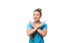 Fitness trainer wrinkles her nose and does forbiddening gesture with hands. Caucasian attractive woman with funny upset