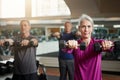 Fitness, training and senior people with dumbbells at gym for club exercise, wellness or cardio, health or strength Royalty Free Stock Photo
