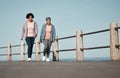 Fitness, walking and senior women by ocean for healthy lifestyle, wellness and cardio on promenade. Sports, friends and