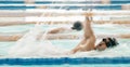 Fitness, water and a swimmer in a pool during a race, competition or cardio training at a gym. Exercise, sports and Royalty Free Stock Photo