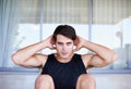 Fitness is a way of life. A portrait of a focused young man doing sit ups at home. Royalty Free Stock Photo