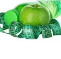 Fitness, weight loss concept with green apples, bottle of drinking water and tape measure Royalty Free Stock Photo