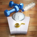 Fitness and weight loss concept. Weigh scales, dumbells and meas