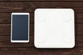 Fitness and weight loss concept, white scale and tablet on wooden table, top view Royalty Free Stock Photo