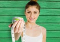 fitness woman apple and meter with green wood background Royalty Free Stock Photo