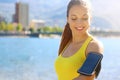 Fitness woman with arm band for phone technology doing running marathon exercise jogging stretching warm up in the morning in city Royalty Free Stock Photo