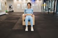 Fitness woman in blue sportswear doing triceps exercises on wooden crossfit jump box at gym. Royalty Free Stock Photo