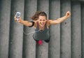 Fitness woman with cell phone outdoors in the city Royalty Free Stock Photo