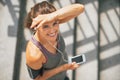 Fitness woman with cell phone outdoors in city Royalty Free Stock Photo