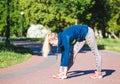 Fitness woman doing exercises during outdoor cross training workout in sunny morning Royalty Free Stock Photo