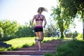 Fitness woman doing exercises during outdoor cross training workout in sunny morning Royalty Free Stock Photo
