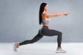 Fitness woman doing lunges exercises for leg muscle workout training. Active girl doing front forward one leg step lunge exercise Royalty Free Stock Photo