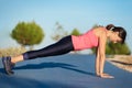Fitness woman doing push-ups during outdoor cross training workout Royalty Free Stock Photo