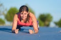 Fitness woman doing push-ups during outdoor cross training workout Royalty Free Stock Photo