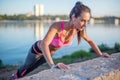 Fitness woman doing push ups Outdoor training workout summer evening side view Concept sport healthy lifestyle. Royalty Free Stock Photo