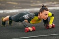 Fitness woman doing push-ups in the stadium, cross training workout. Sporty girl training outside Royalty Free Stock Photo