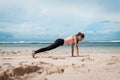 Fitness woman doing yoga exercises. Girl training her abs exercising core muscles with the plank pose. Royalty Free Stock Photo