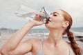 Fitness, woman and drinking water at the beach after running, exercise or cardio workout in Cape Town. Female runner Royalty Free Stock Photo