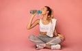 Fitness Woman Drinking Water Sitting On Floor In Studio Royalty Free Stock Photo