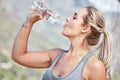 Fitness, woman and drinking water on workout break for hydration, recovery or running exercise in nature. Thirsty active Royalty Free Stock Photo