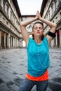 Fitness woman with earphones doing yoga outdoors. Florence Royalty Free Stock Photo